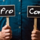 Photo of a man holding pros and cons cards