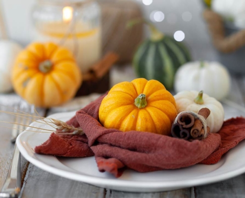 Photo of pumpkins and candle on a wooden table