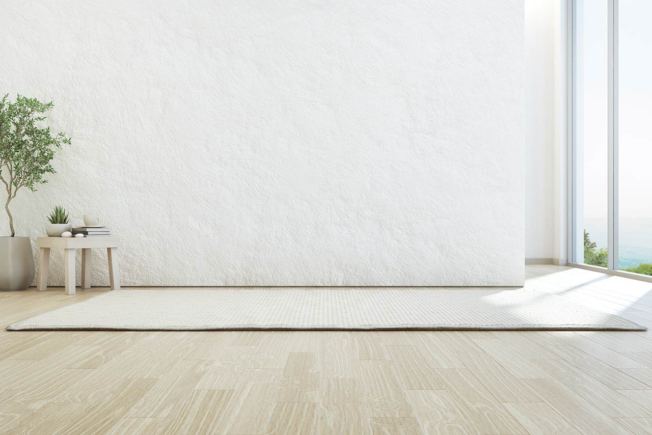 Image of a living area with a side table, rug, and no sofa