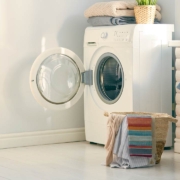 Interior of a real laundry room with a washing machine at home