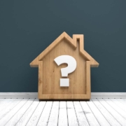 Wooden home icon and question mark on white wood floor
