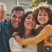 Happy family, portrait and real estate with keys in property, investment or new home together