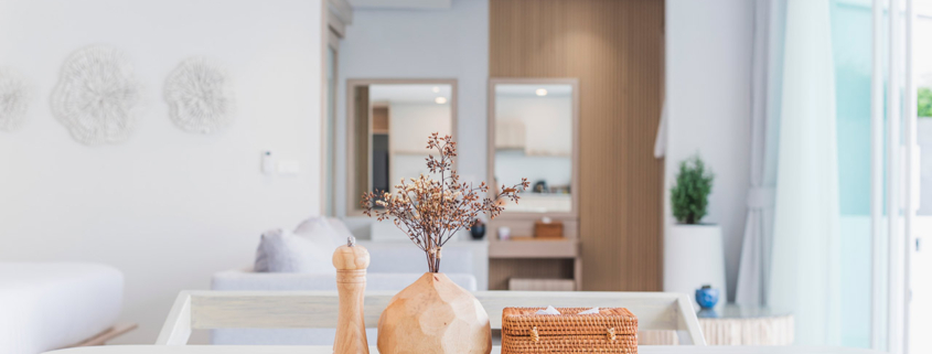 Modern kitchen interior, wooden table, blurred background showing the atmosphere of the room, clean design, home cooking area, neutral colors, natural light stock photo