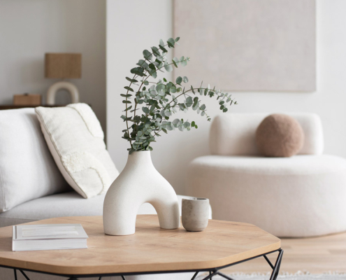 Chair with pillow, coffee table, vase in a living room stock photo
