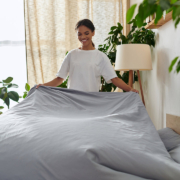 Young african american making a bed stock photo