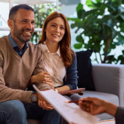 Happy couple having consultations with real estate agent in the office