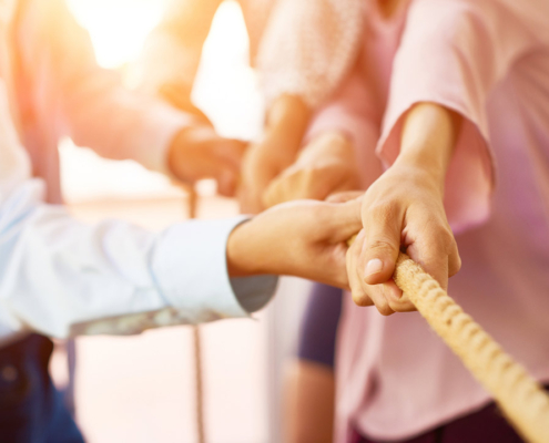 Team of coworker pulling rope together stock photo