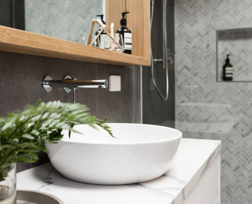 Bathroom details clean white basin with shower tiling behind stock photo