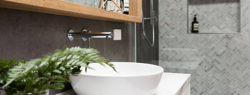 Bathroom details clean white basin with shower tiling behind stock photo