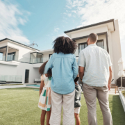 new house and family in their backyard together looking at their property